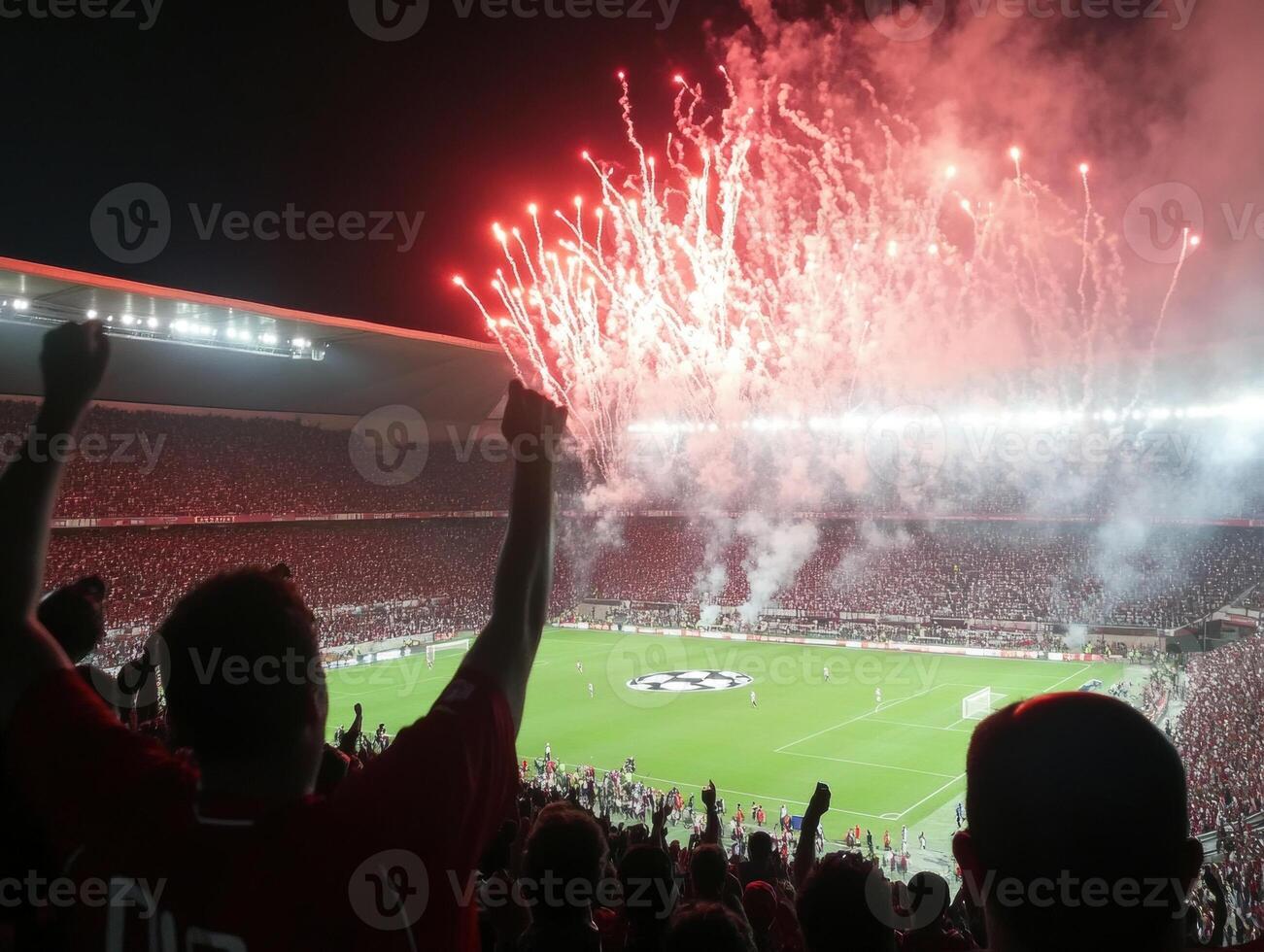 Crowd celebrates during intense football match with fireworks display photo