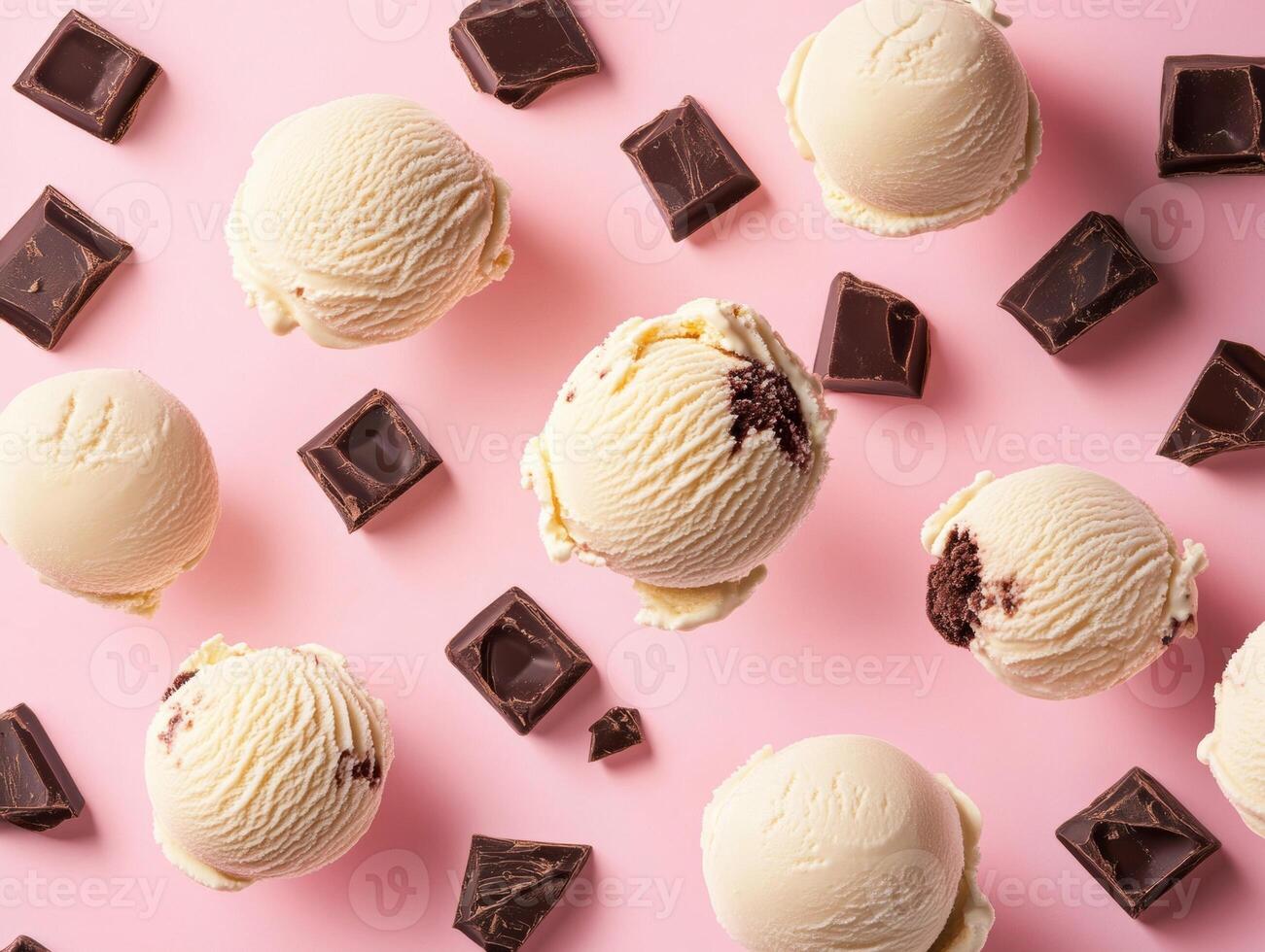 Ice cream scoops with dark chocolate on pink backdrop photo