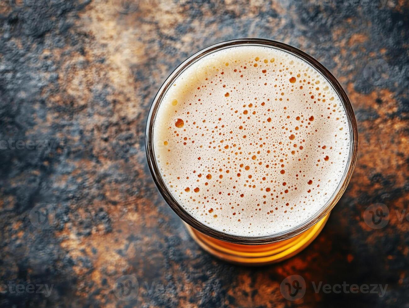 Craft beer served in glass with frothy head on rustic background photo