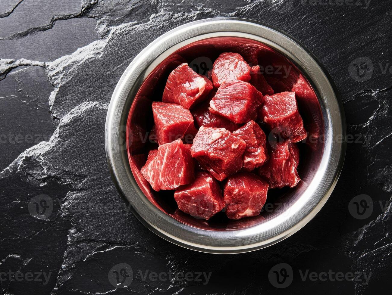 Freshly chopped beef cubes on a slate surface ready for cooking photo
