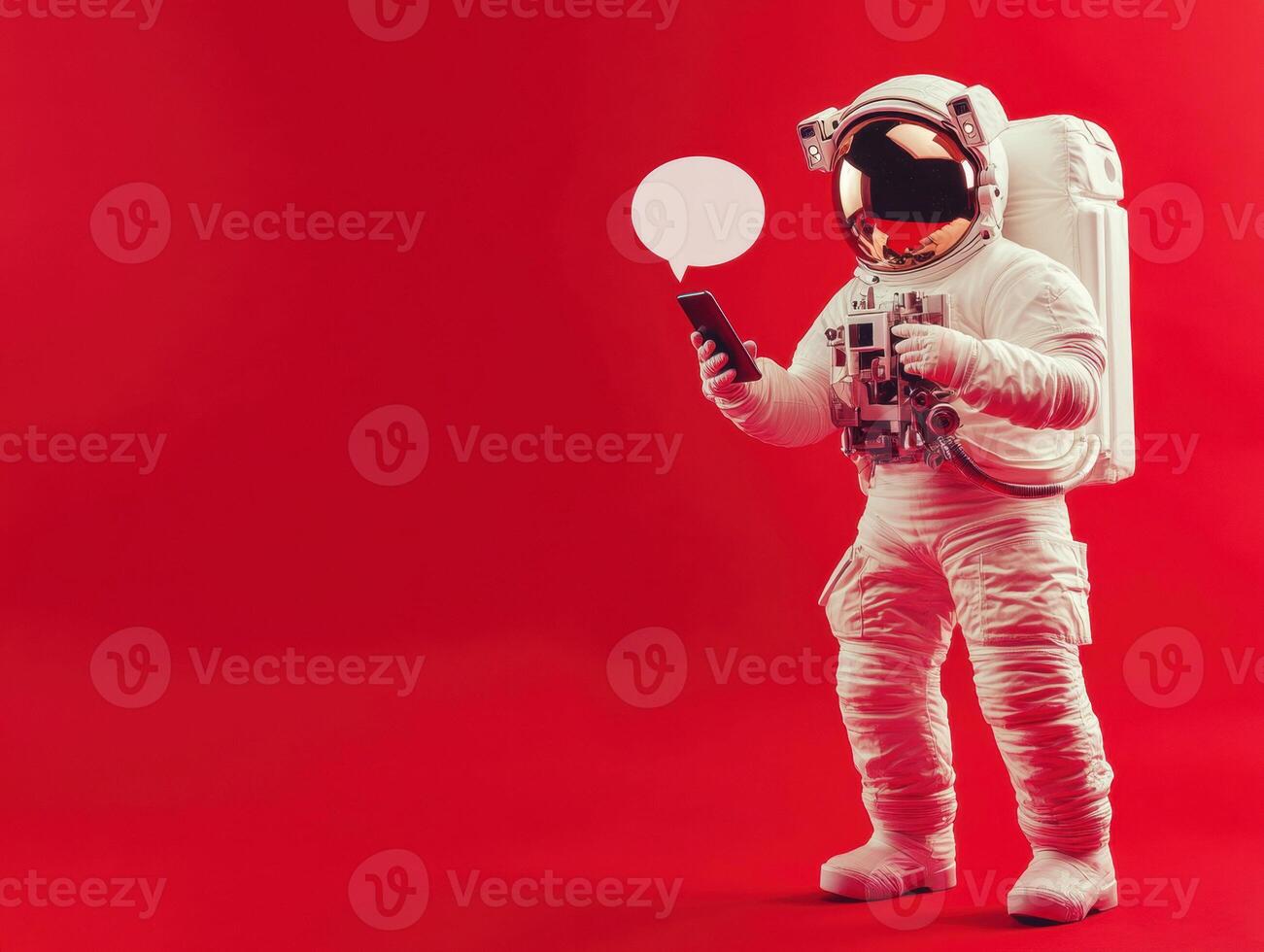 Astronaut engaging with smartphone against bright red background photo