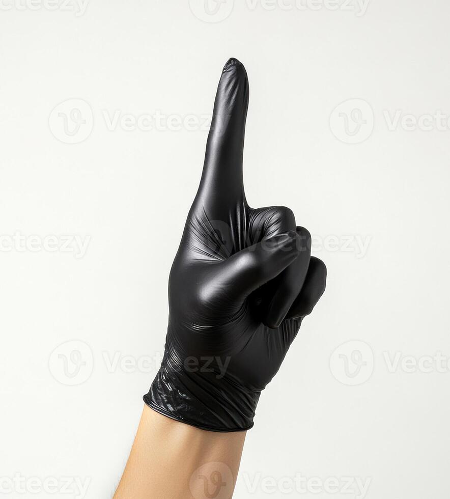Raised hand with black glove signaling stop in neutral setting photo