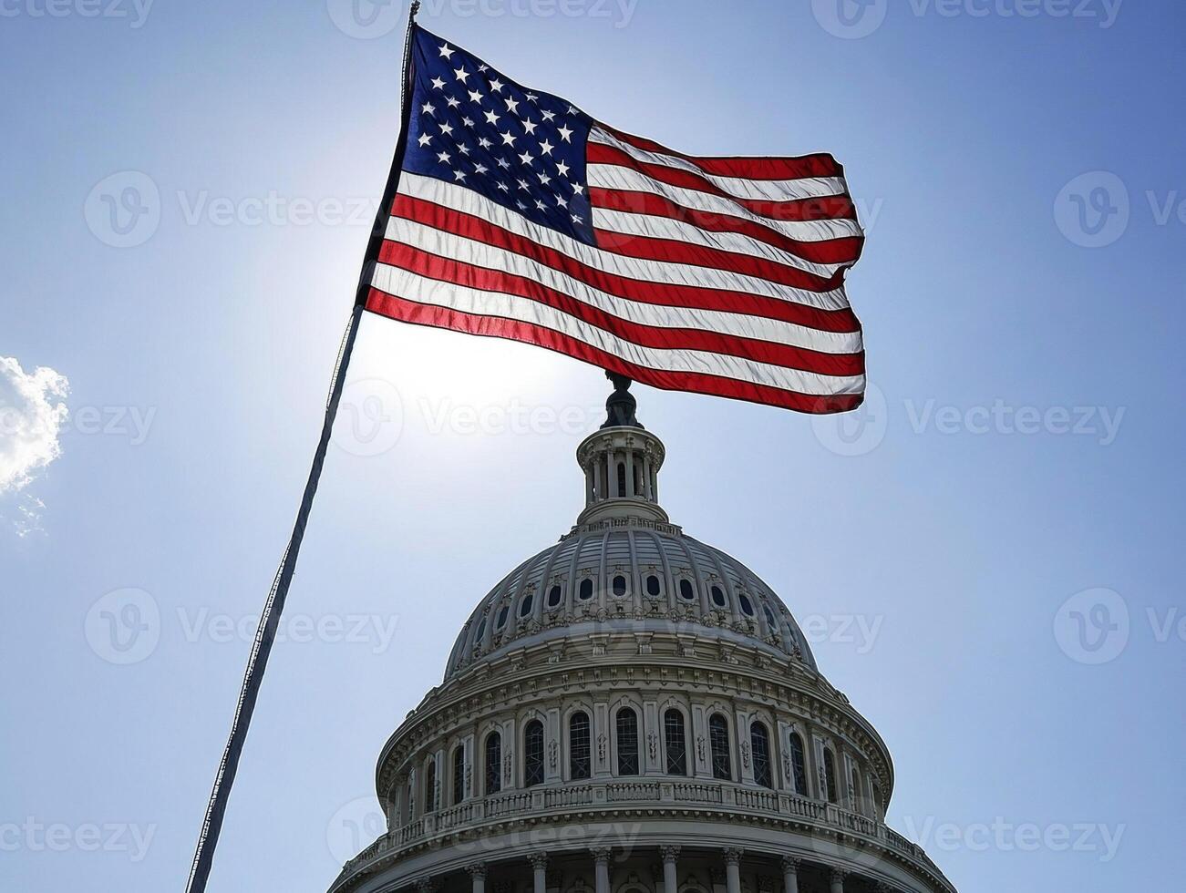 US flag waves over Capitol building during clear day photo