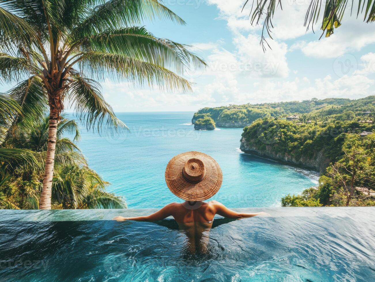 Relaxing in a serene infinity pool with ocean view in Bali photo