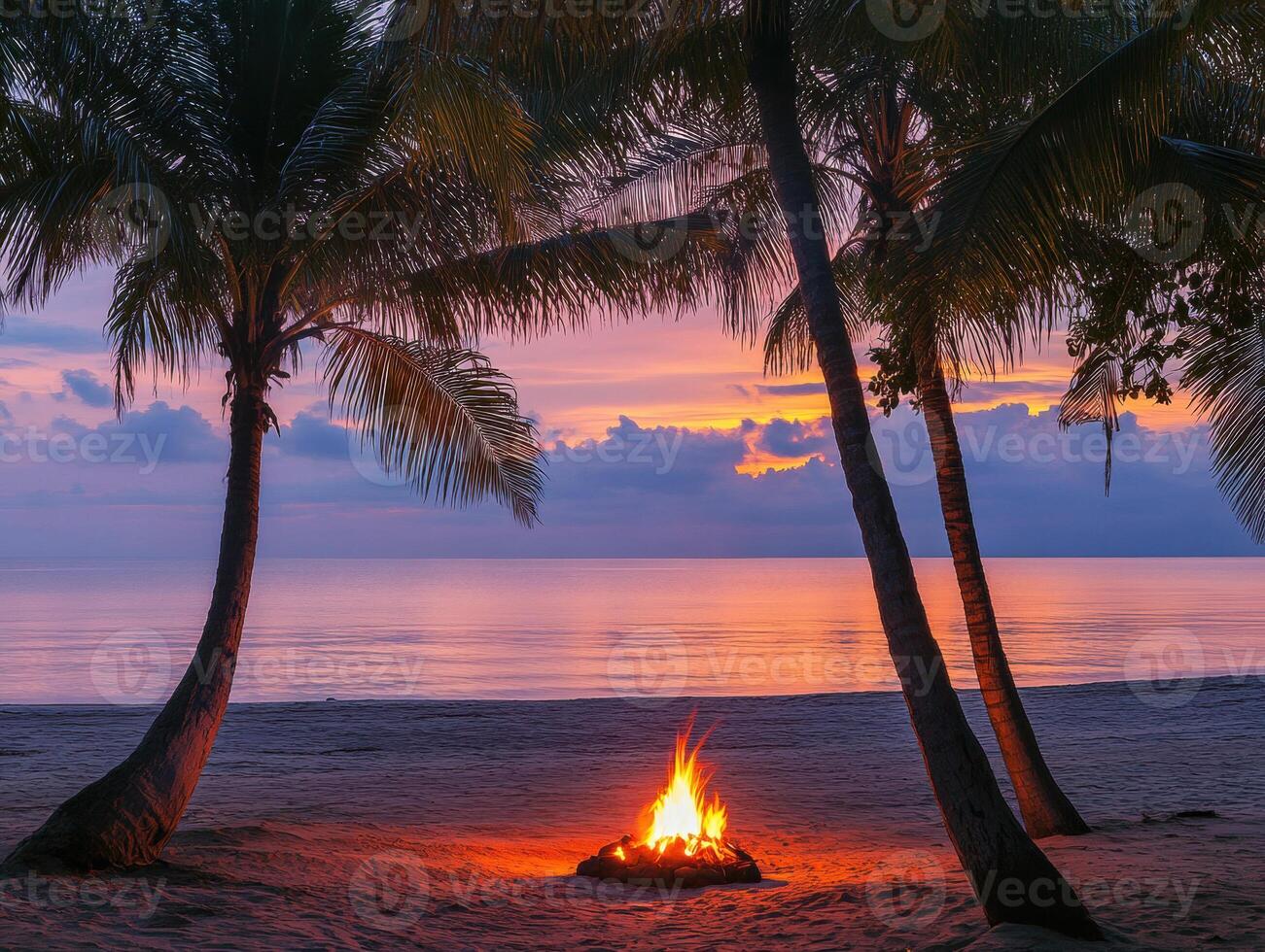 Sunset beach bonfire with palm trees and tranquil ocean view photo