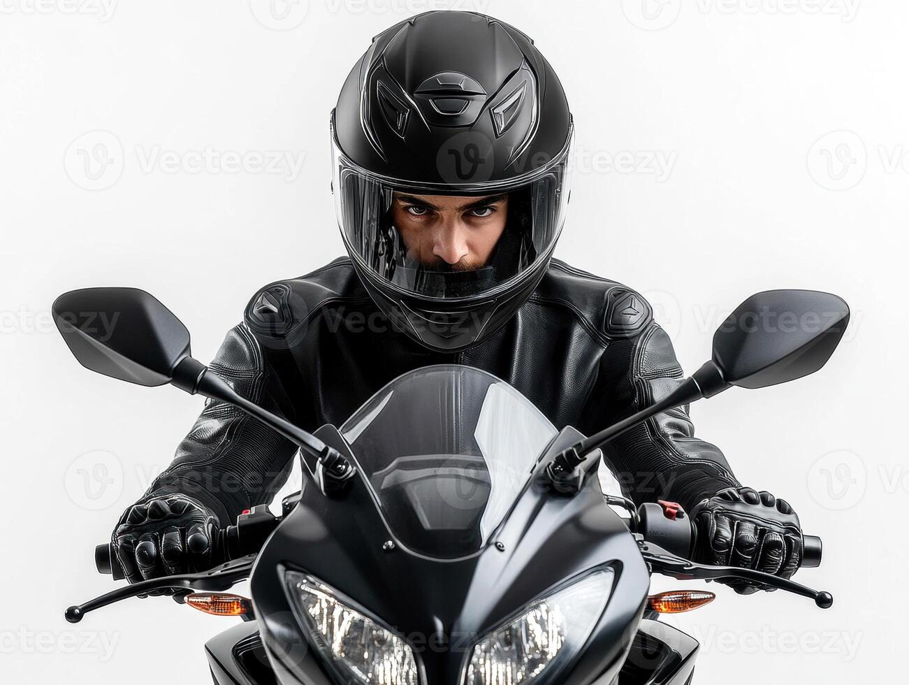 Rider in black helmet focuses on motorcycle in studio setting photo