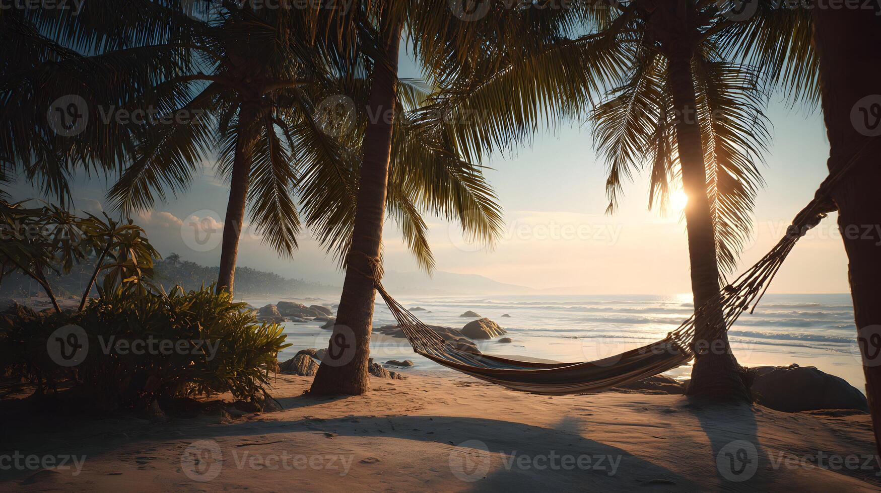 Tropical beach paradise with hammock swaying gently between palm trees at sunset photo