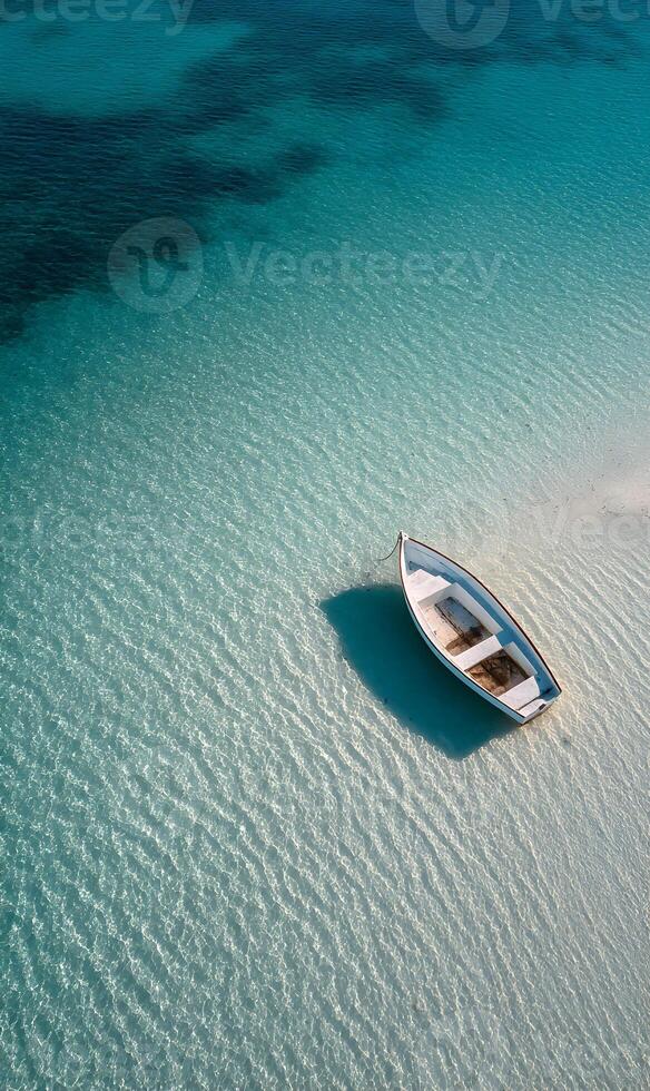 Serene boat resting on shallow turquoise waters in a tropical location on a sunny day photo