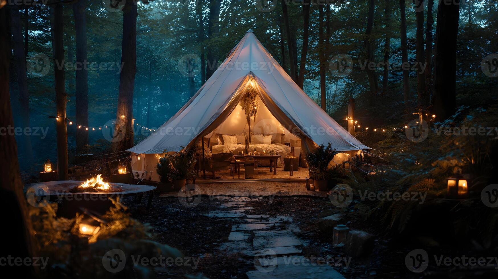 Idyllic glamping experience inside a comfortable tent surrounded by a dark forest at night photo