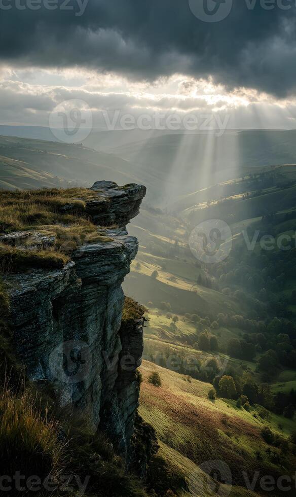 Dramatic Peak District vista featuring sun rays shining through the clouds in England photo