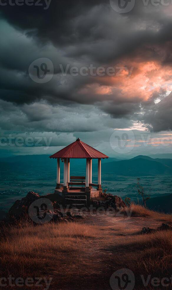 Peaceful retreat with mountain view gazebo under a dramatic cloudscape at sunset photo