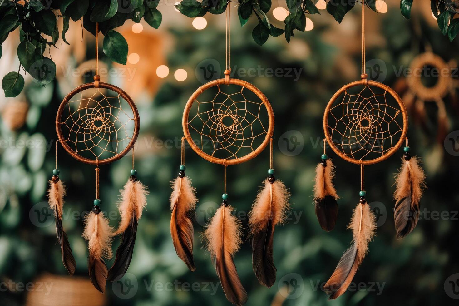 Three dream catchers hanging with feathers and turquoise beads photo