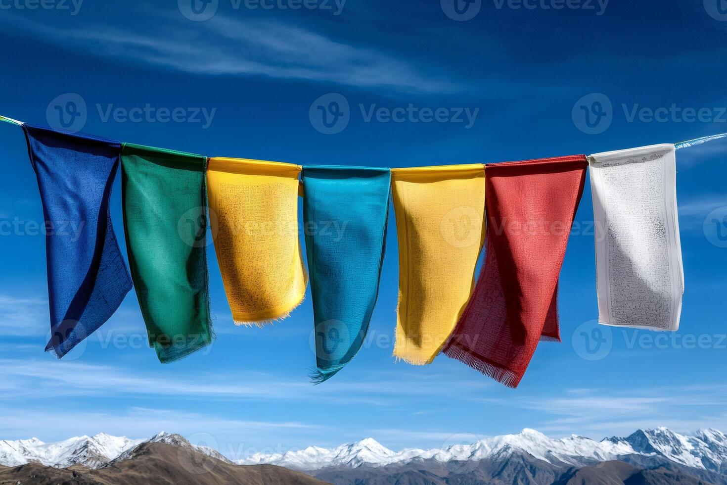 Prayer flags waving in the wind with snowy himalayas mountains in background photo