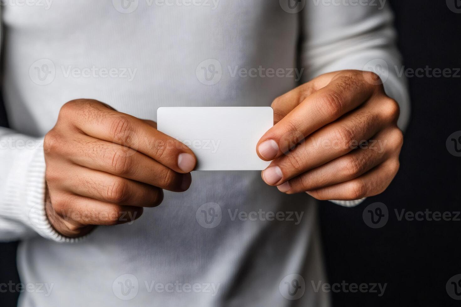 Businessman showing blank business card on black background photo