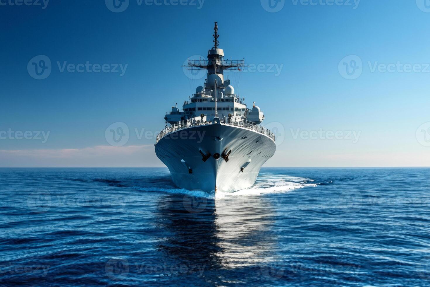 Modern warship sailing in the blue ocean on a sunny day photo