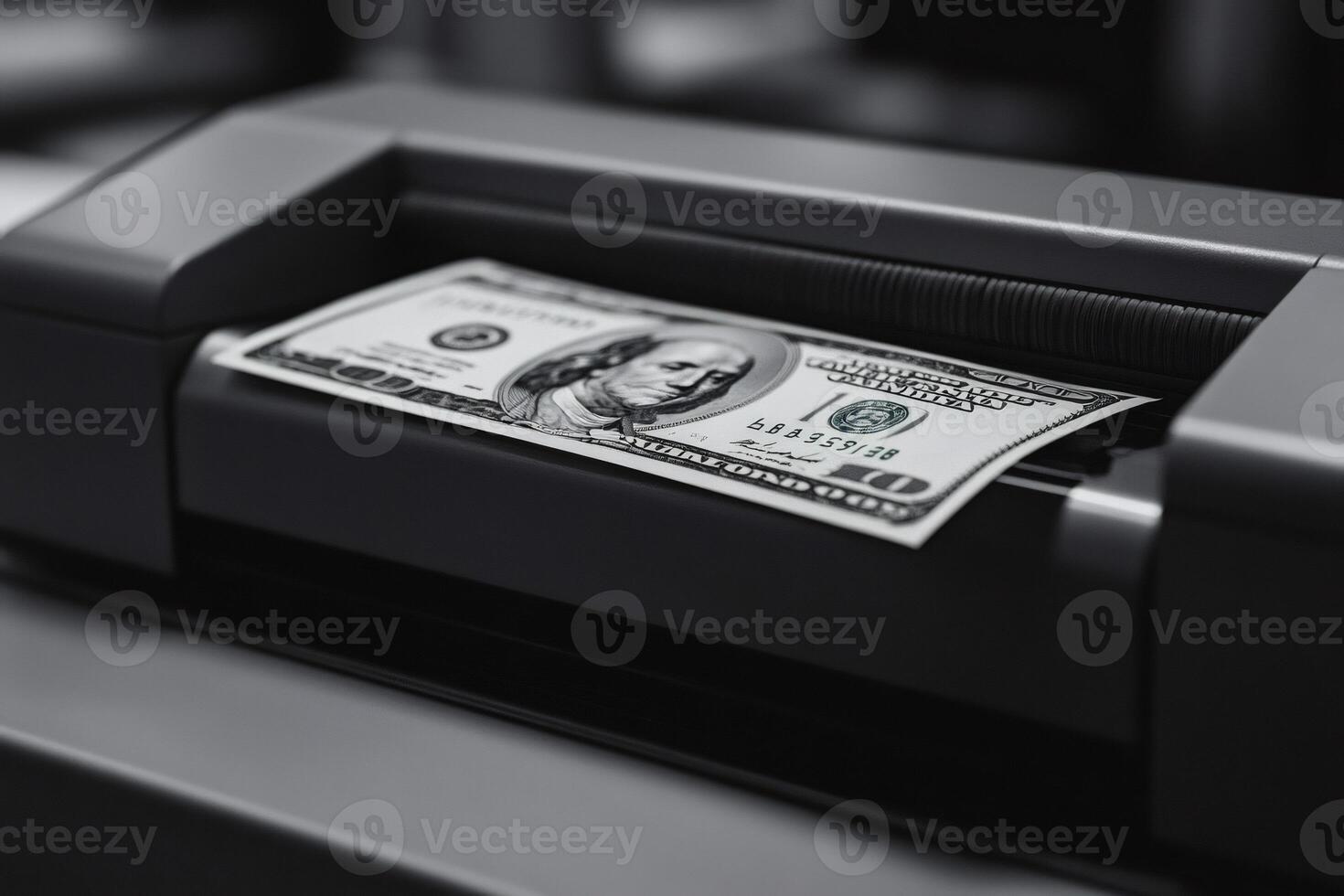 Counterfeit money being printed using a printer and one hundred dollar bill photo