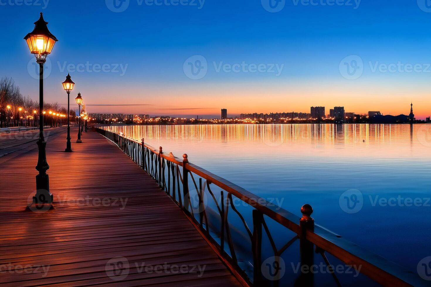 Wooden pier with street lamps stretching into tranquil city skyline at dusk photo