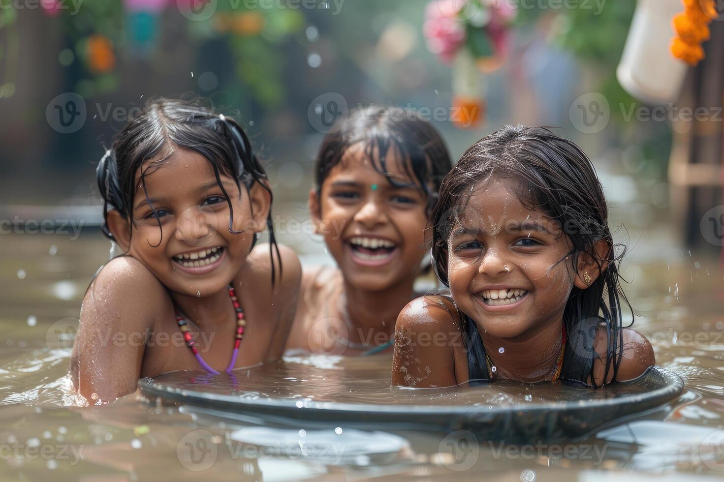 Three young girls having fun bathing and playing in water photo