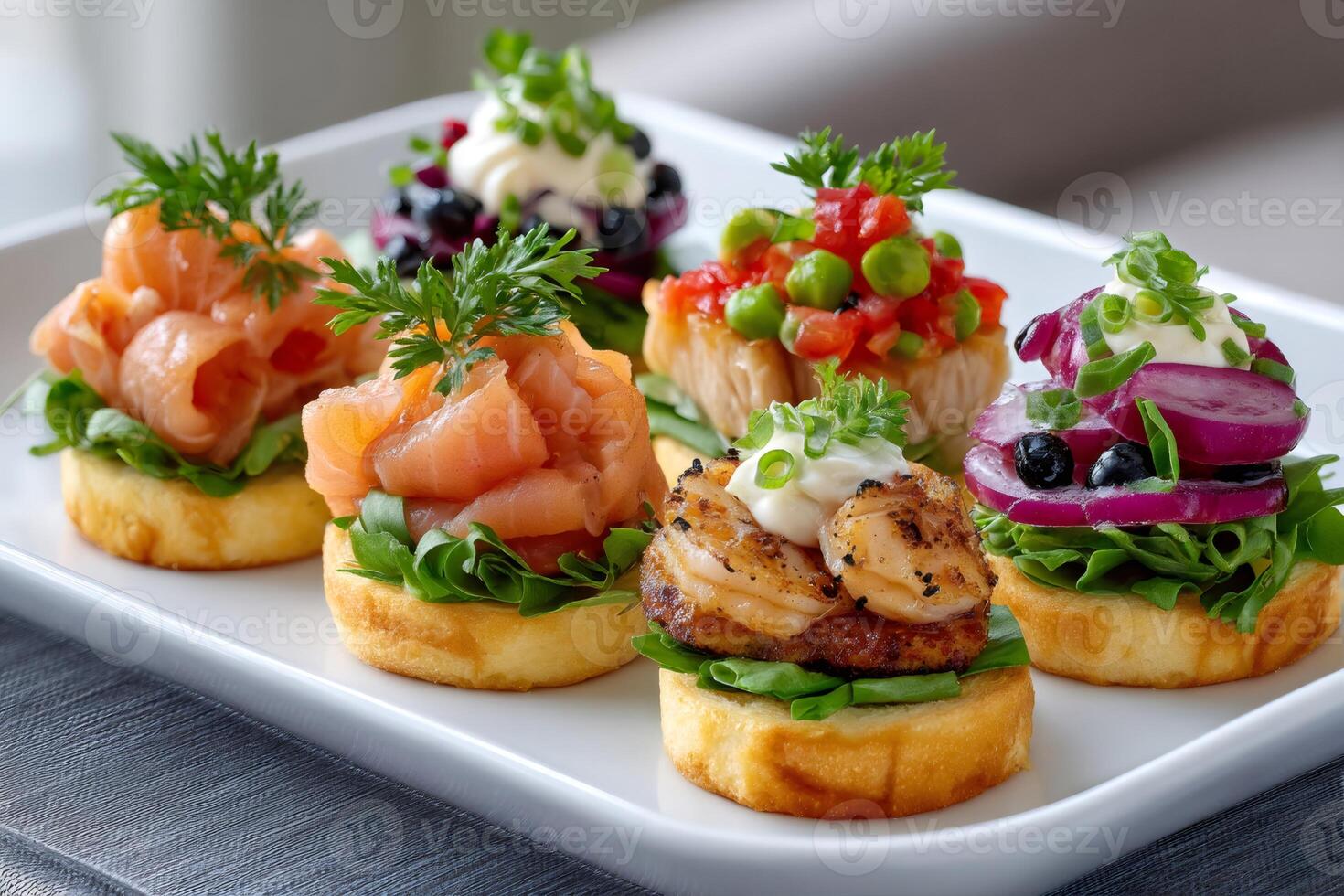 Delicious canapes with salmon, shrimps, vegetables and berries decorating a festive table photo