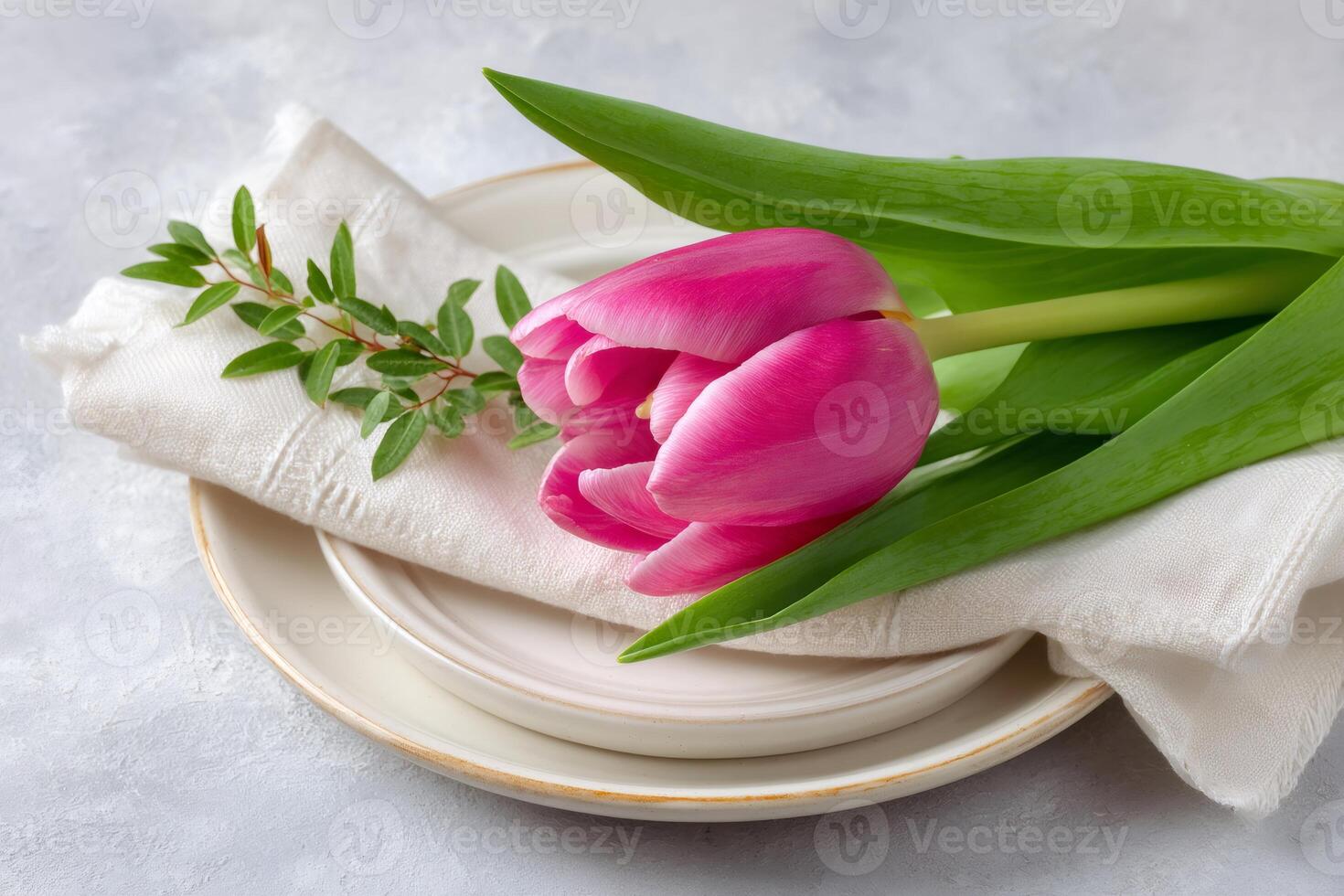 Pink tulip decorating a table setting for a festive spring celebration photo