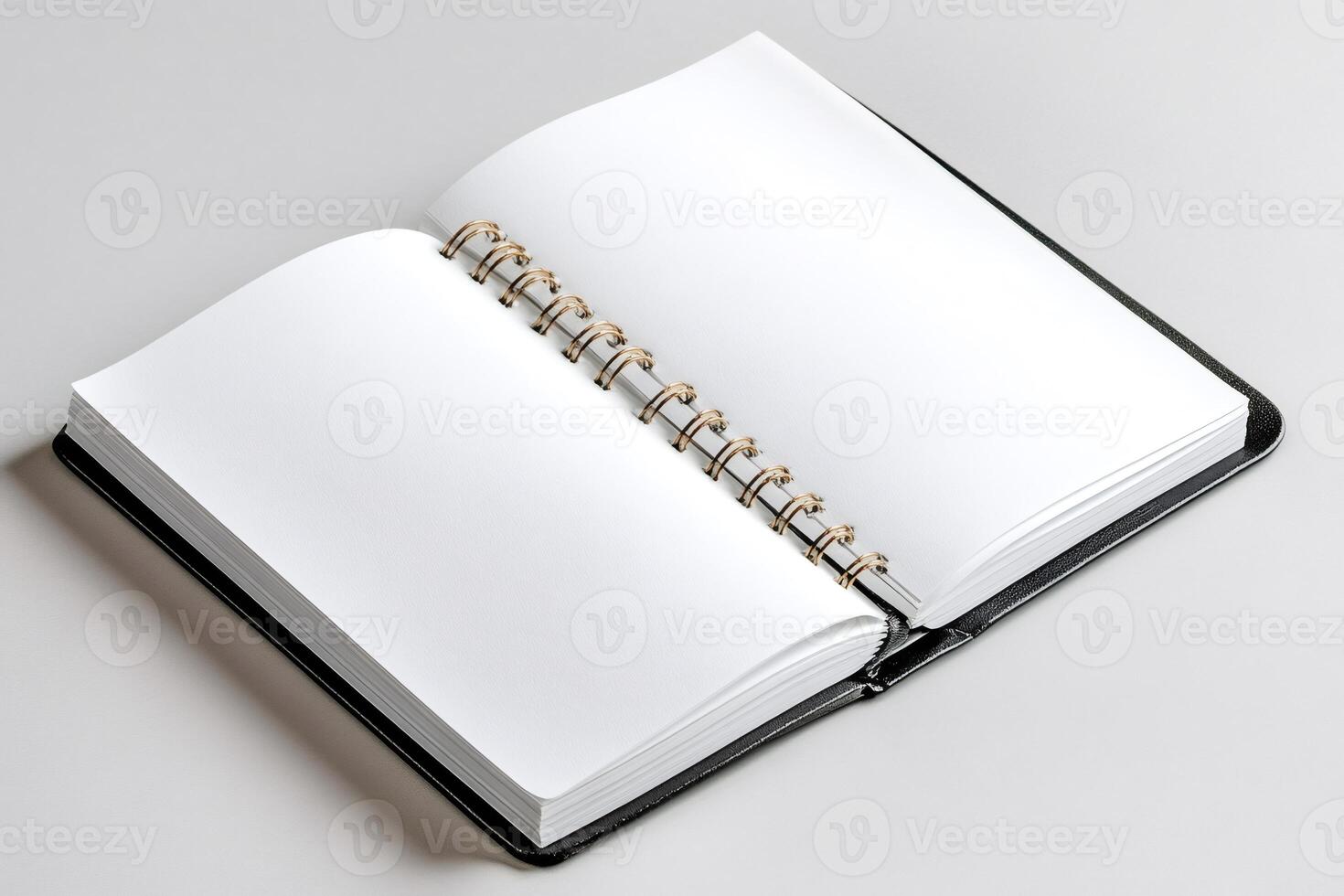 Open notebook with blank pages showing binding on gray background photo