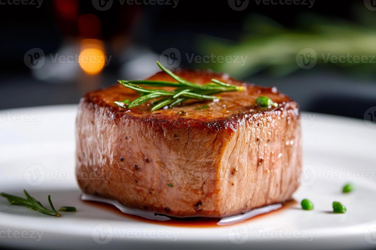 Juicy grilled beef steak with rosemary resting on white plate photo