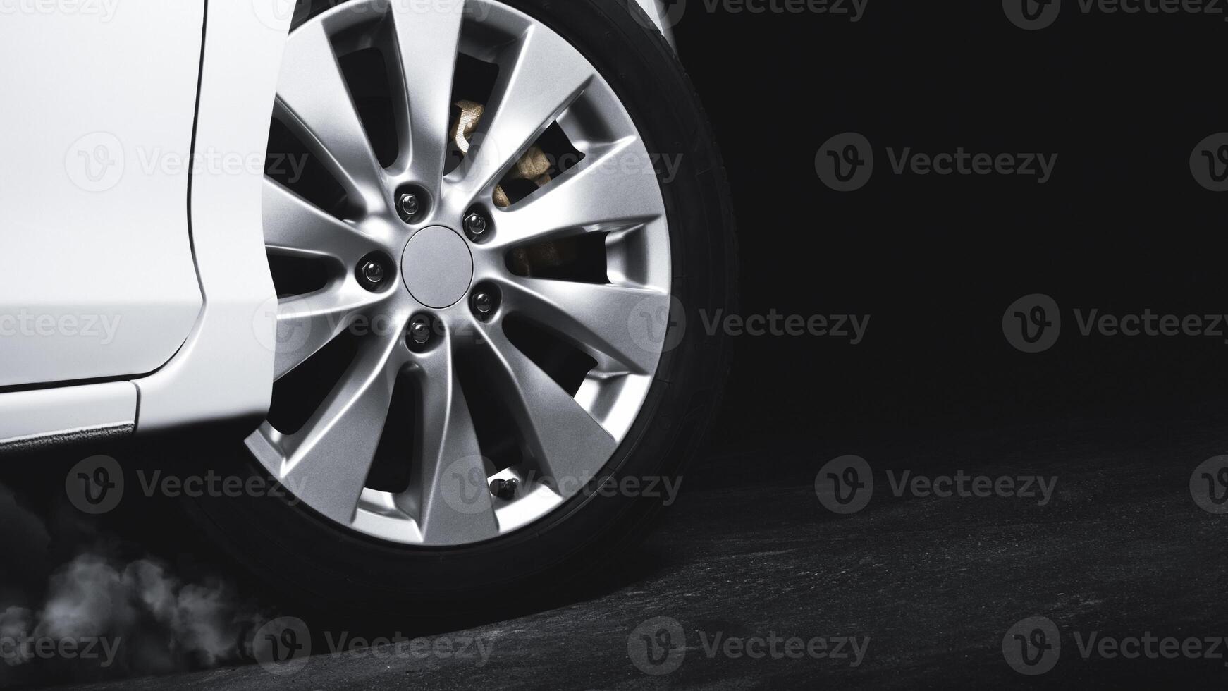 Luxury Metallic Car Wheel, Close-up of a alloy wheel with tire of car on black background. photo