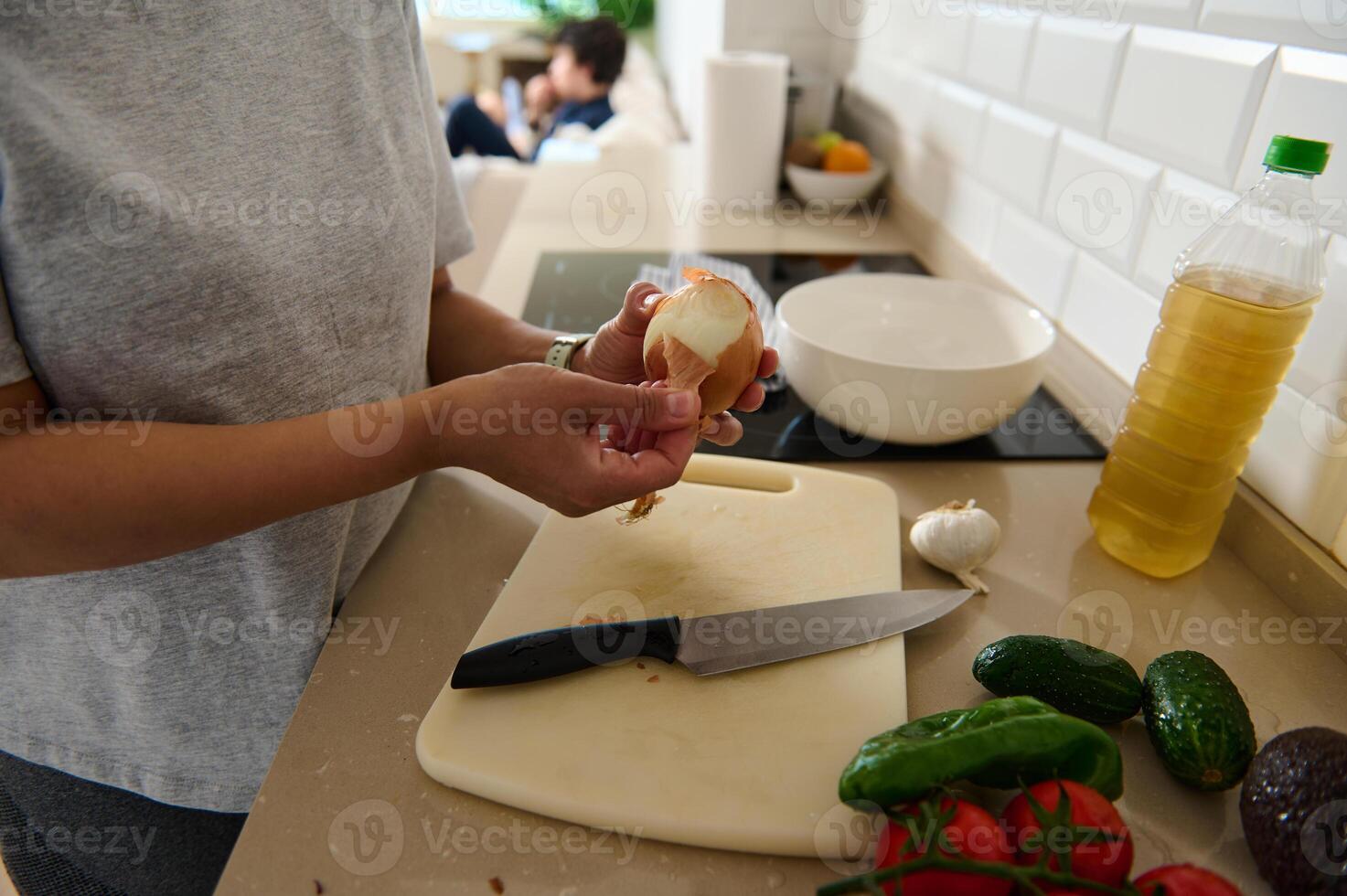 Person Preparing Vegetables and Ingredients in a Modern Kitchen photo