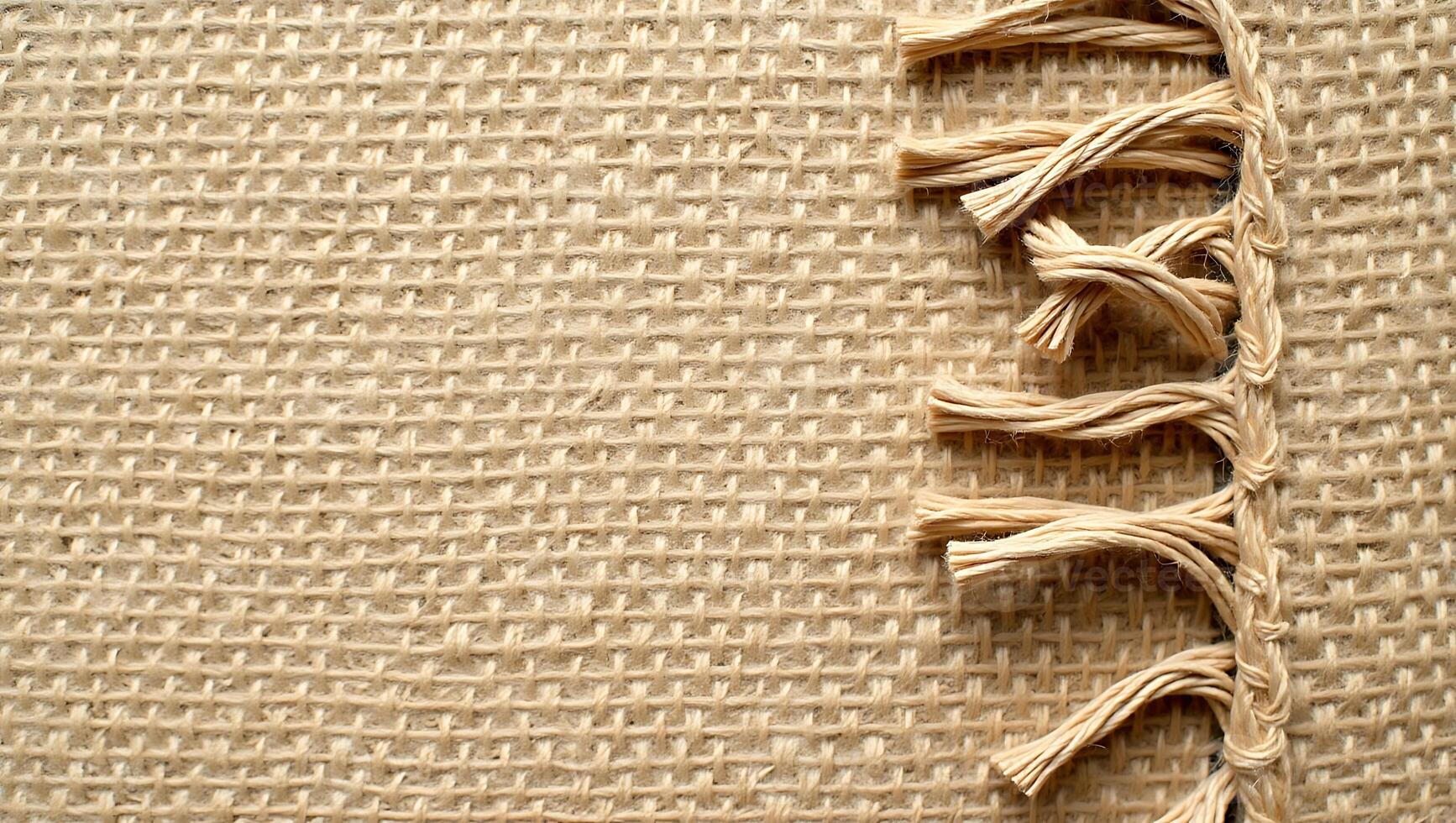 Close up view of burlap fabric with decorative stitching for rustic backgrounds and designs photo