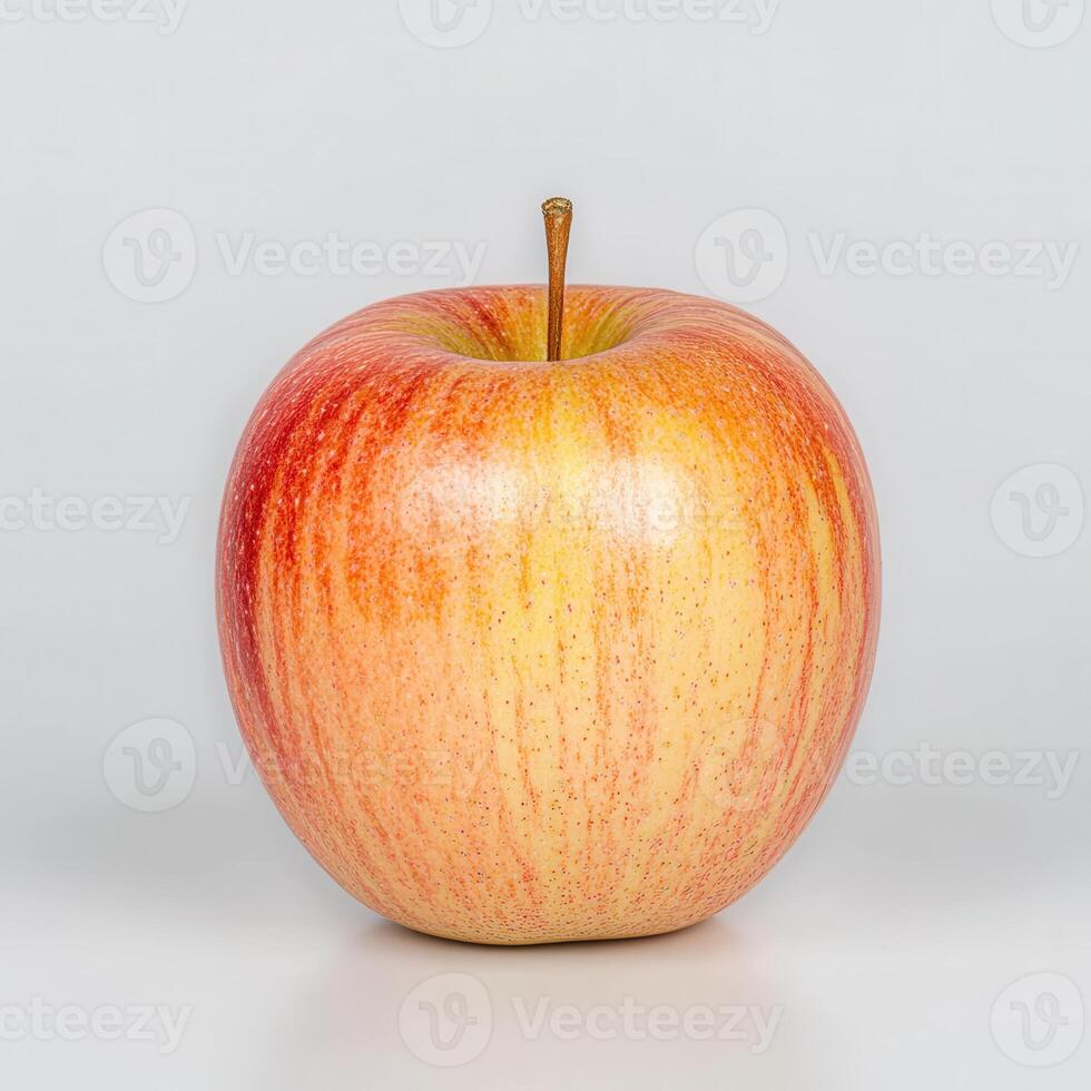 Red and Yellow Striped Apple on White Background photo