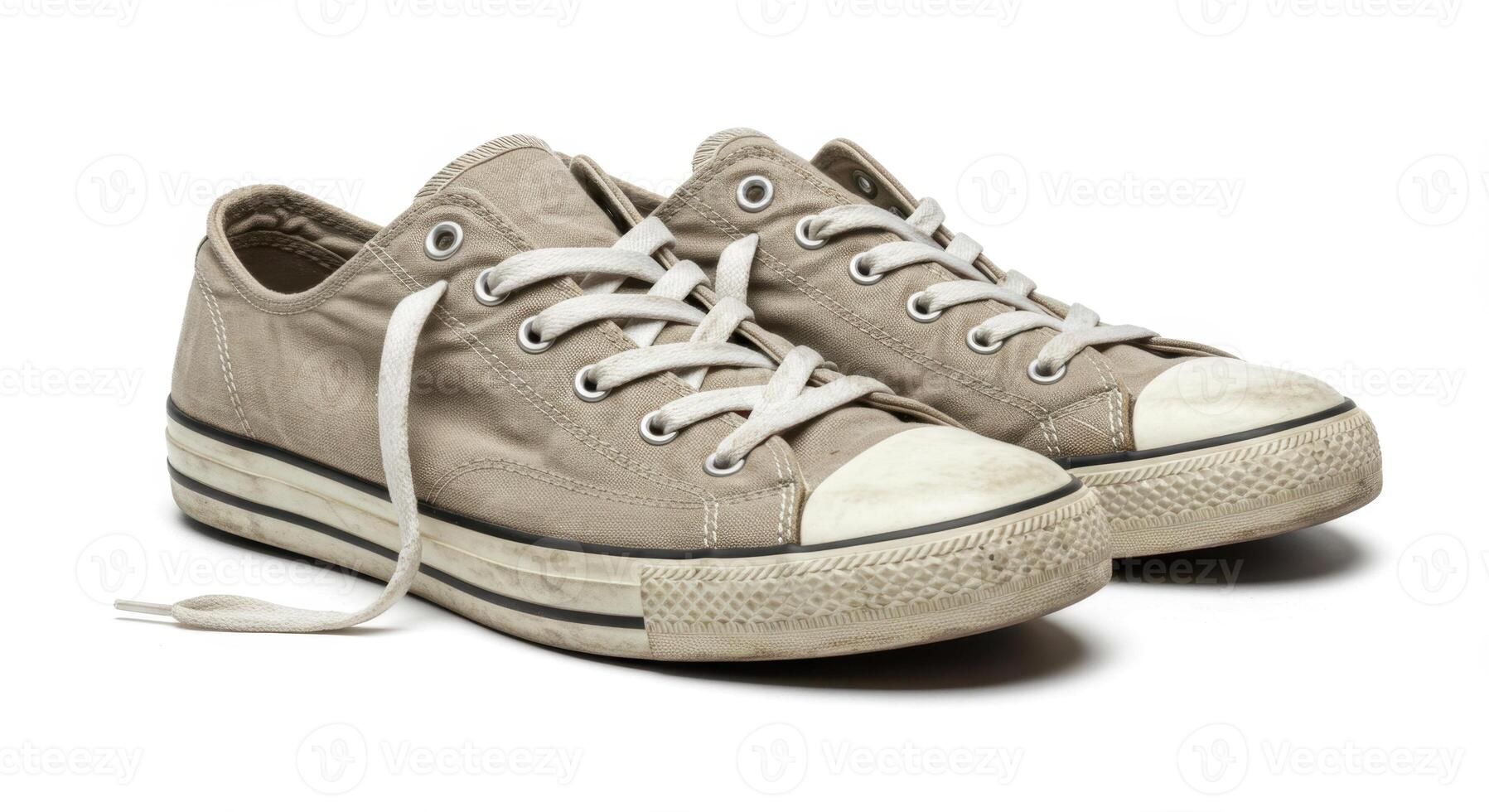Worn Beige Canvas Sneakers with Loose Laces on White Background photo