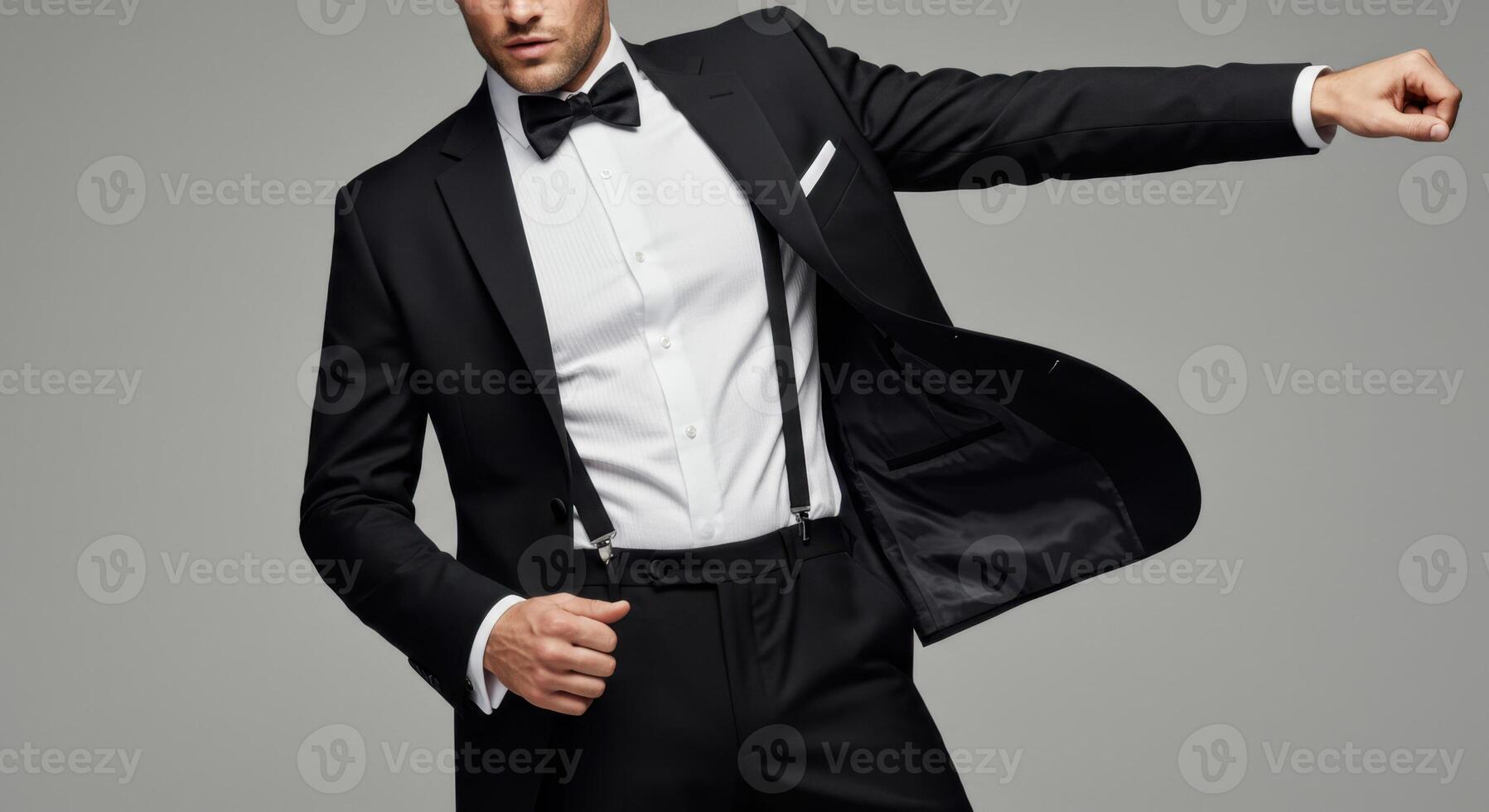 Elegant Man in Black Tuxedo and Suspenders Striking a Bold Pose photo
