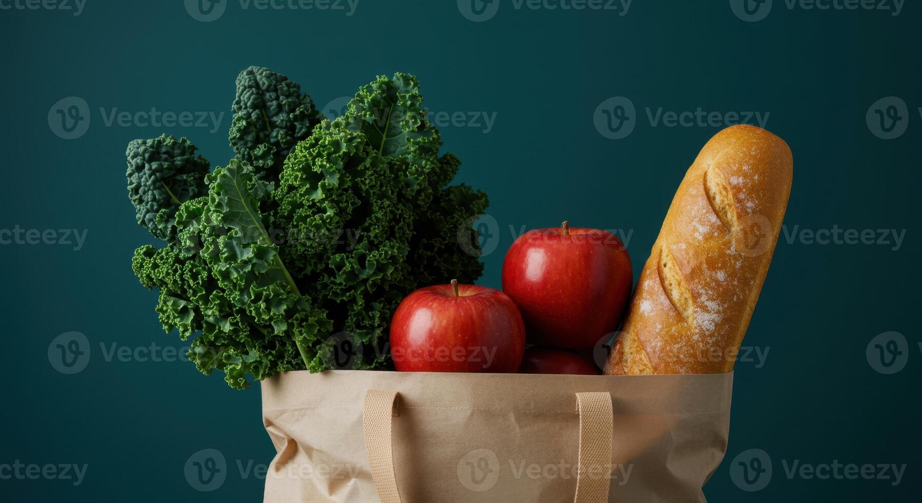 Paper Grocery Bag Filled with Fresh Kale Apples and Baguette on Dark Green Background photo