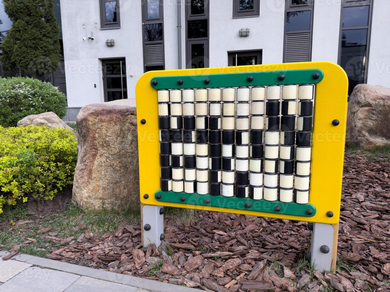 Educational play panel with rotating cubes in park setting. Designed to support cognitive development, coordination, and pattern recognition in young children through interactive learning photo