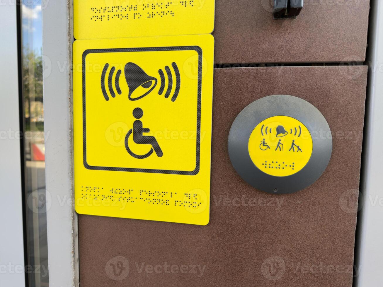 Inclusive access button with Braille and symbols for wheelchair users, elderly people and parents with strollers, mounted near entrance and designed for equal usability in modern public spaces photo