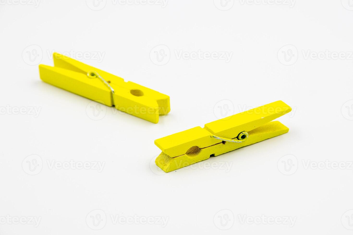 yellow household wooden clothes pins isolated on white background. photo