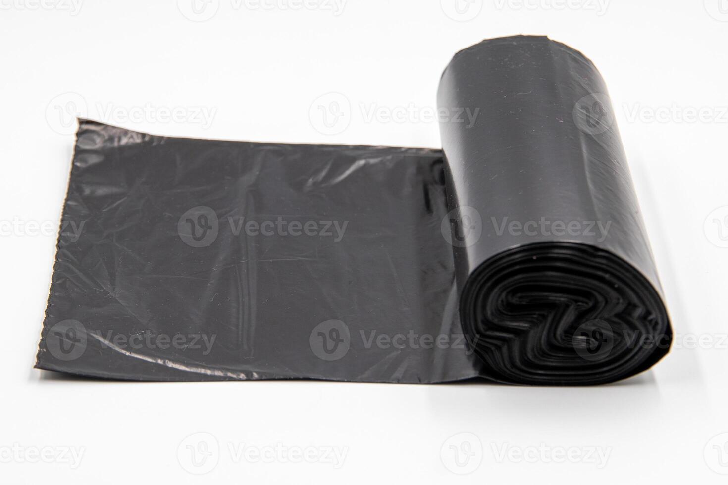 Black plastic garbage bags on white background, Roll of garbage bags isolate on white background photo