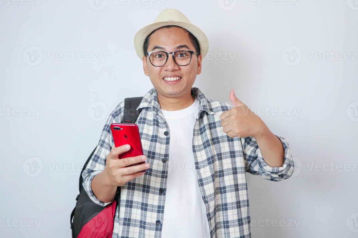 Traveler happy man wear white casual clothes mobile cell phone show thumb up isolated on plain white background. Tourist travel abroad in free time rest getaway Air flight trip concept photo