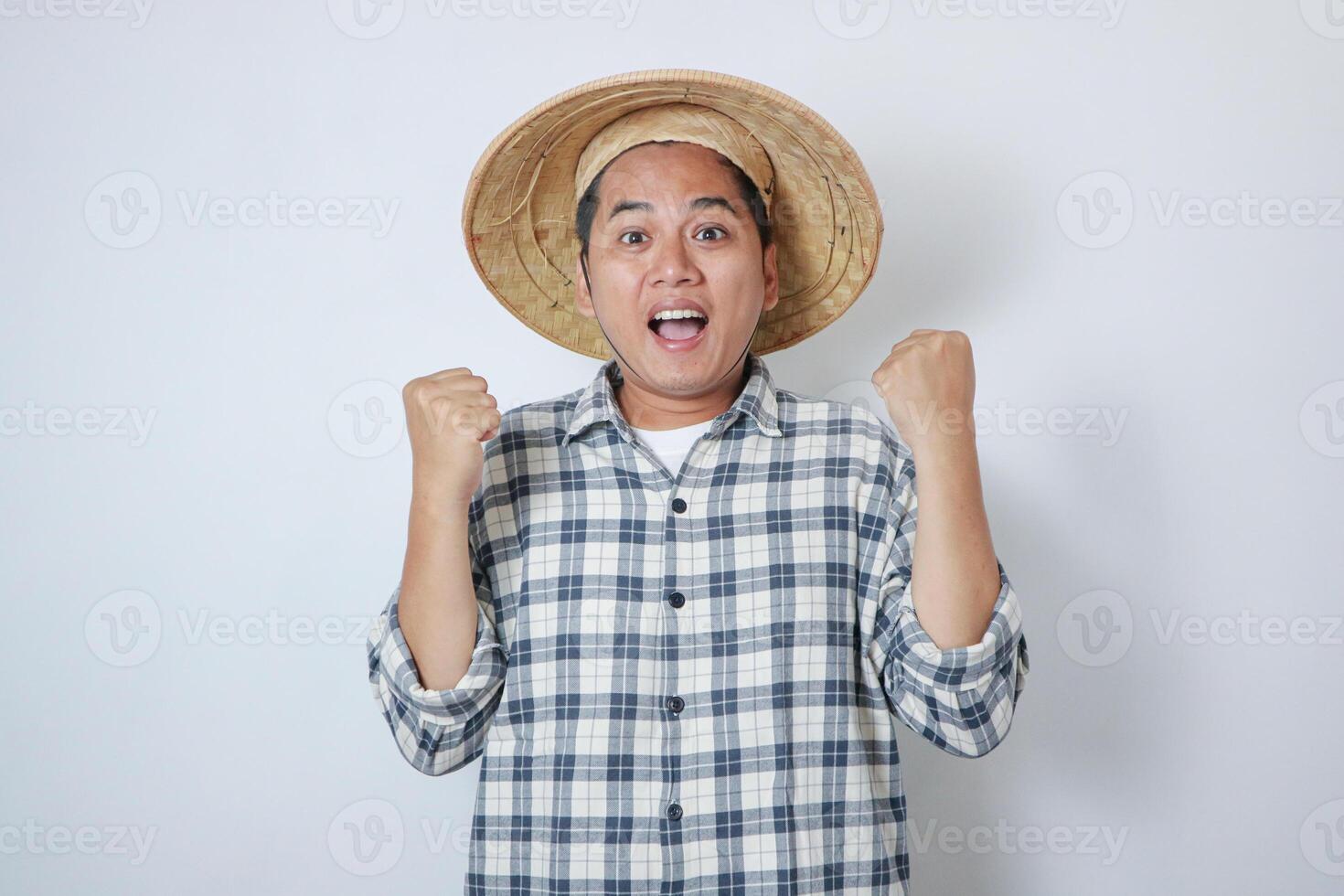 Young Indonesian farmer clench both his hand showing happiness photo