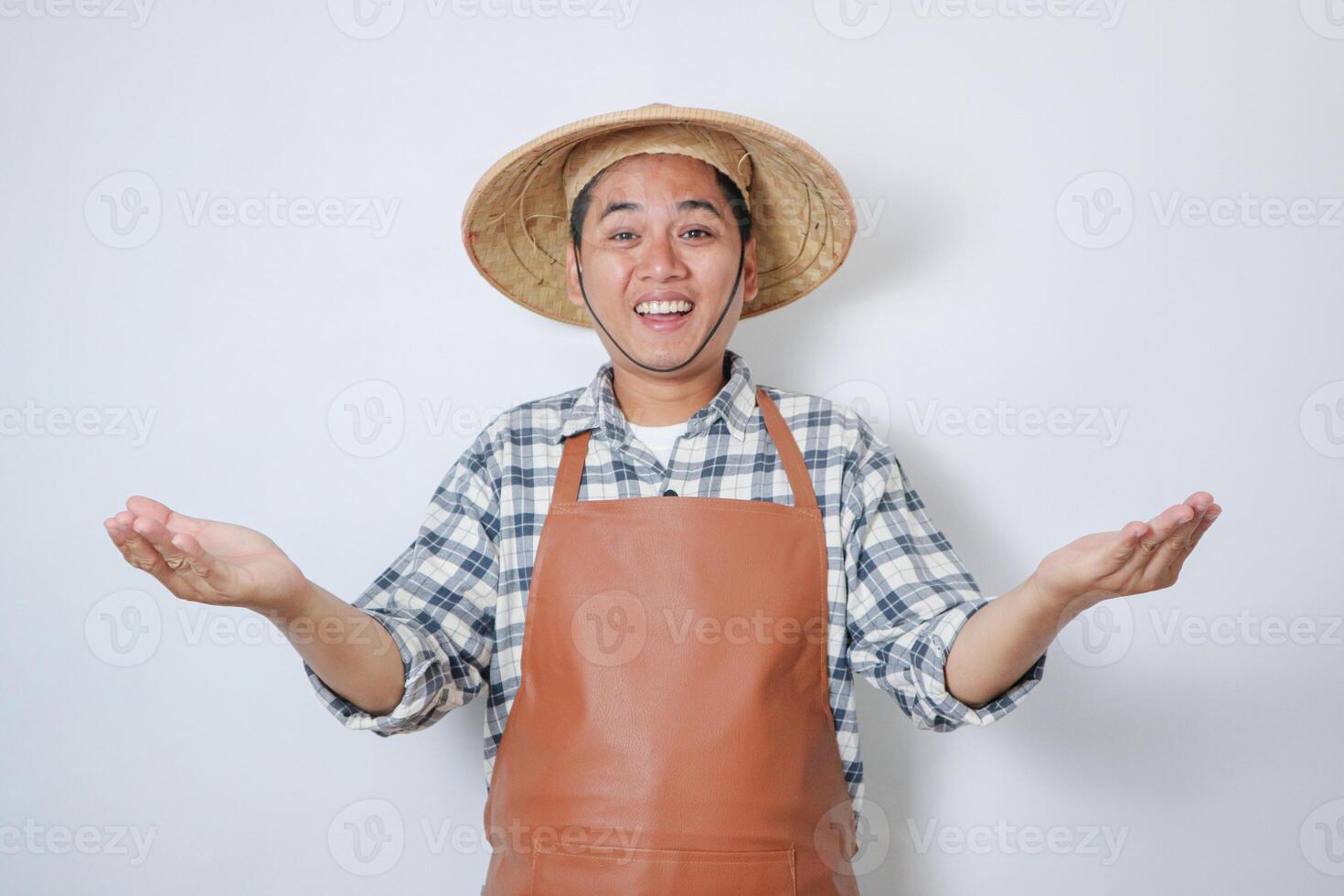 A farmer smiling happy with both hands wide open photo