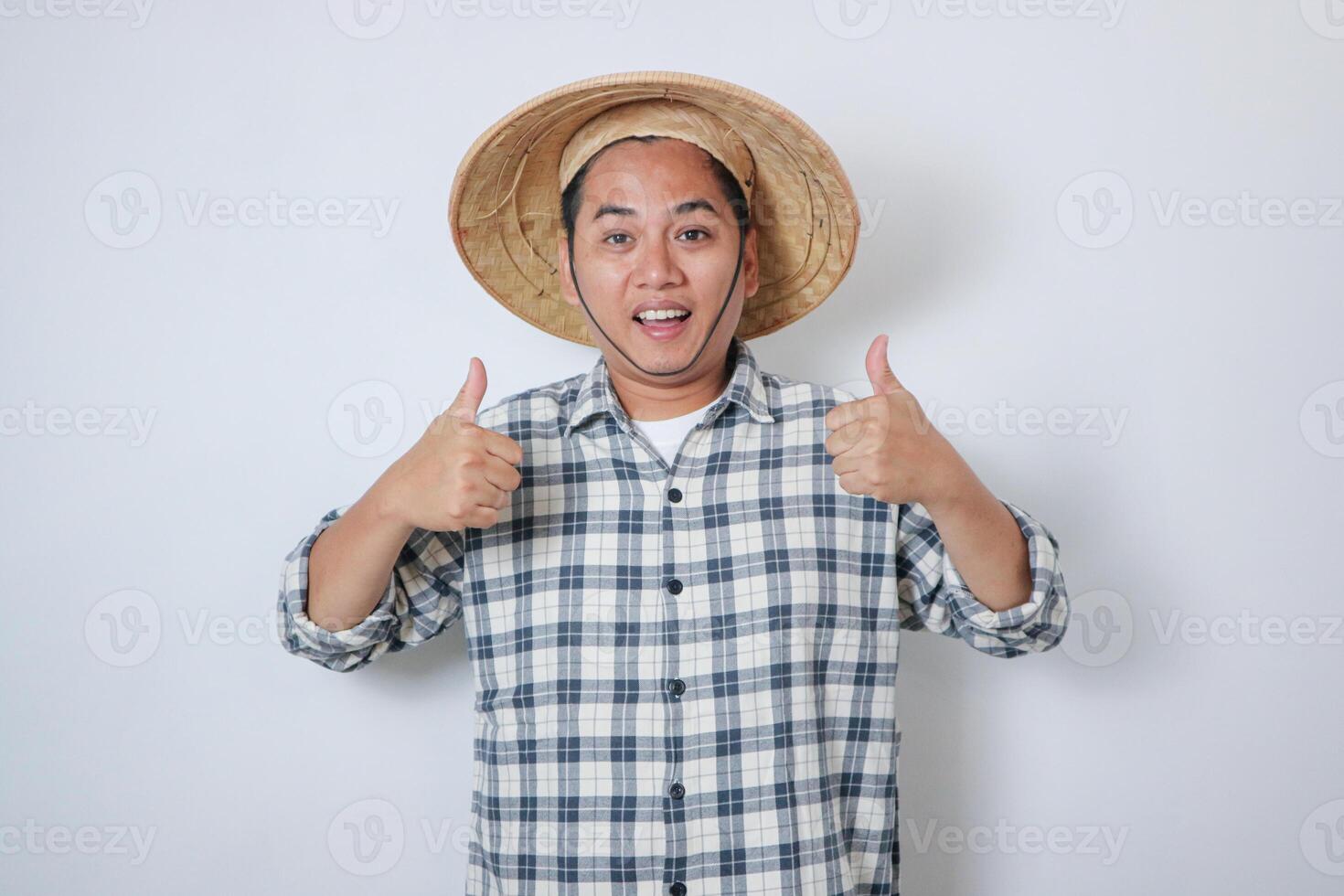 Portrait happy man is smiling. farmer thumb up standing in a shirt and looking at camera at rice field photo