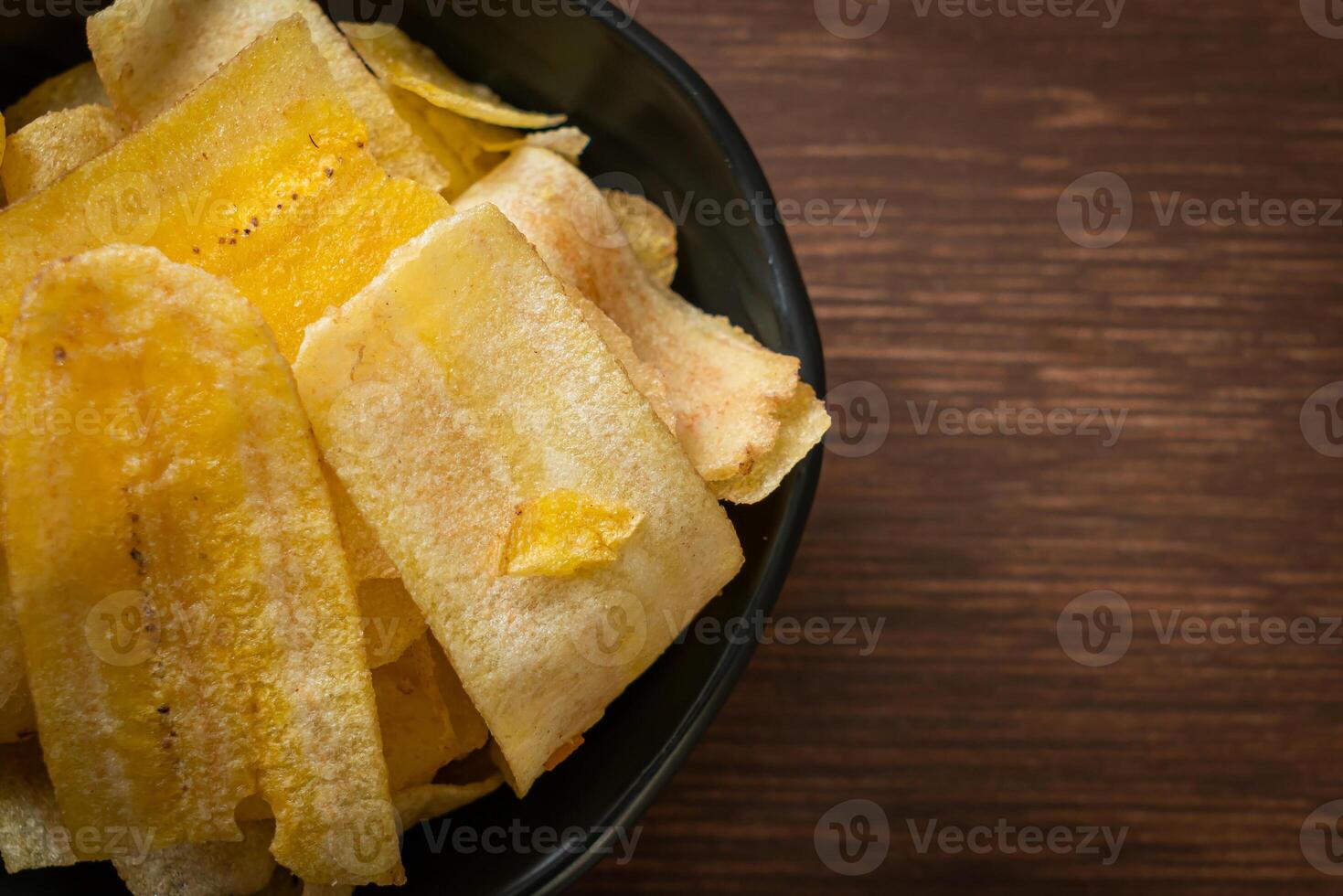 Banana Chips - fried or baked sliced banana with copy space photo