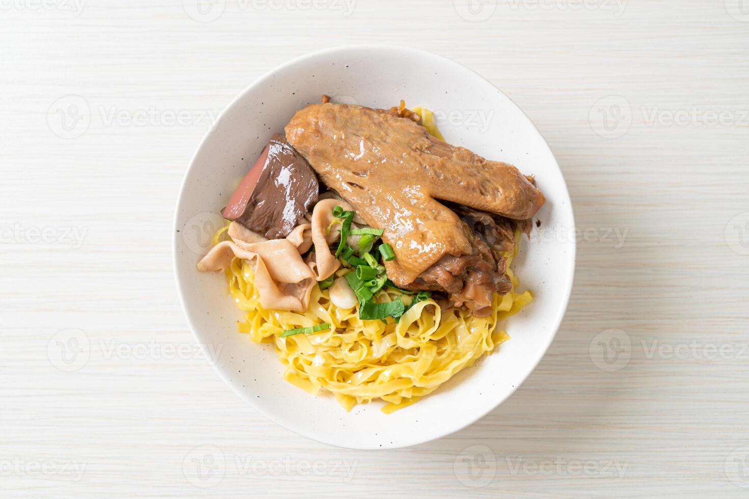 Egg noodles served dry with braised duck - Asian food style photo