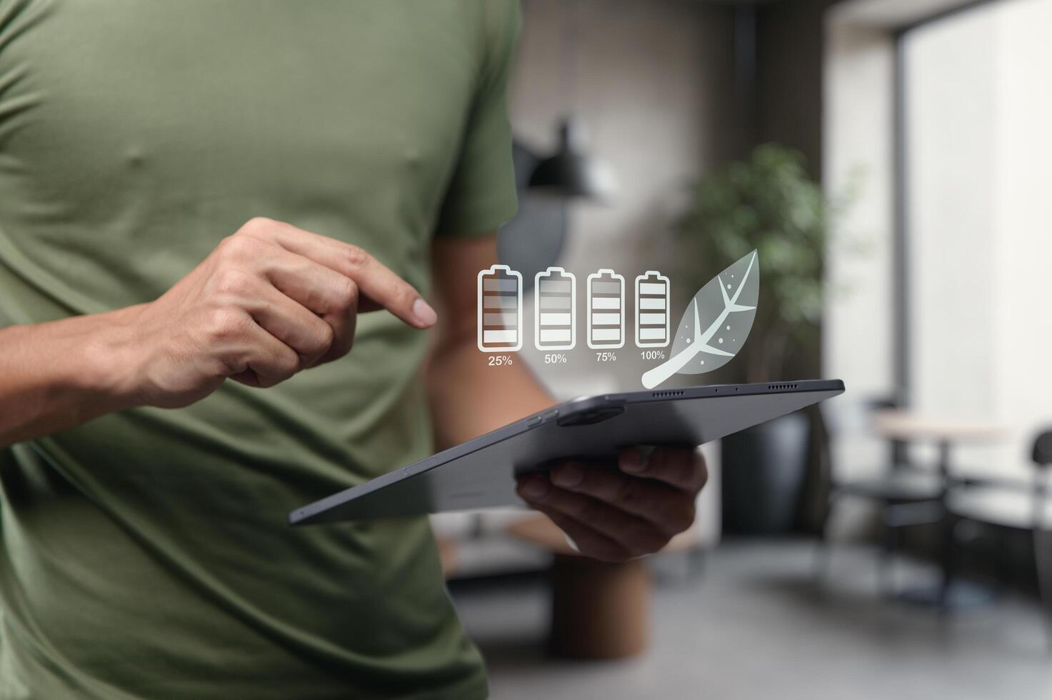 Hands Holding Tablet Displaying Battery Levels and Eco-Friendly Concept photo