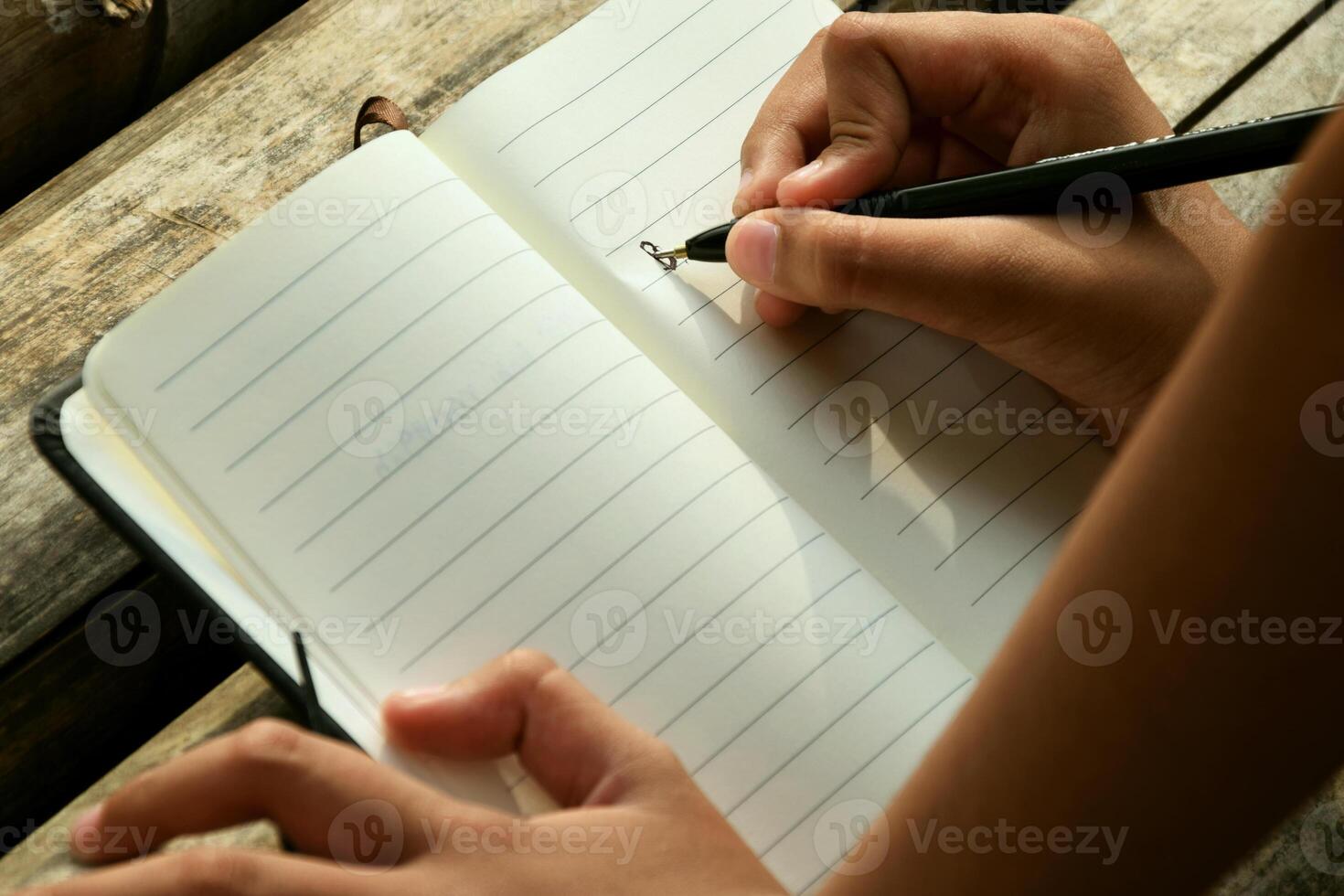 Close Up of Child Writing in Notebook photo