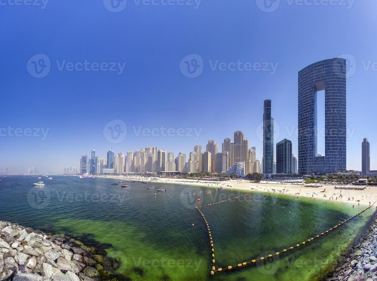Dubai beach with highrise skyline and clear sea water 2 photo