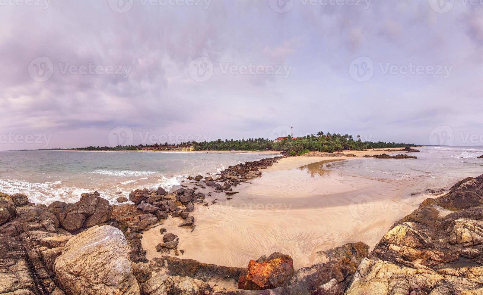 Wide sandy beach with rocks and gentle ocean waves 41 photo