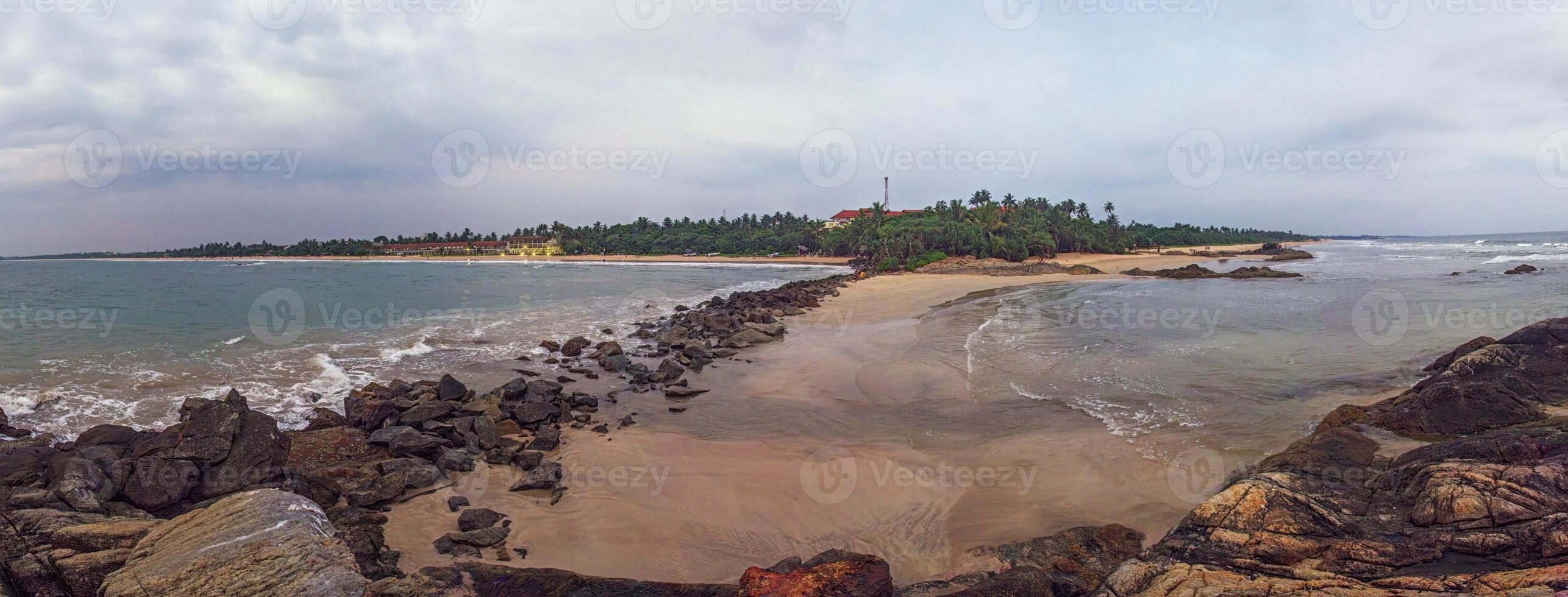 Wide sandy beach with rocks and gentle ocean waves 42 photo