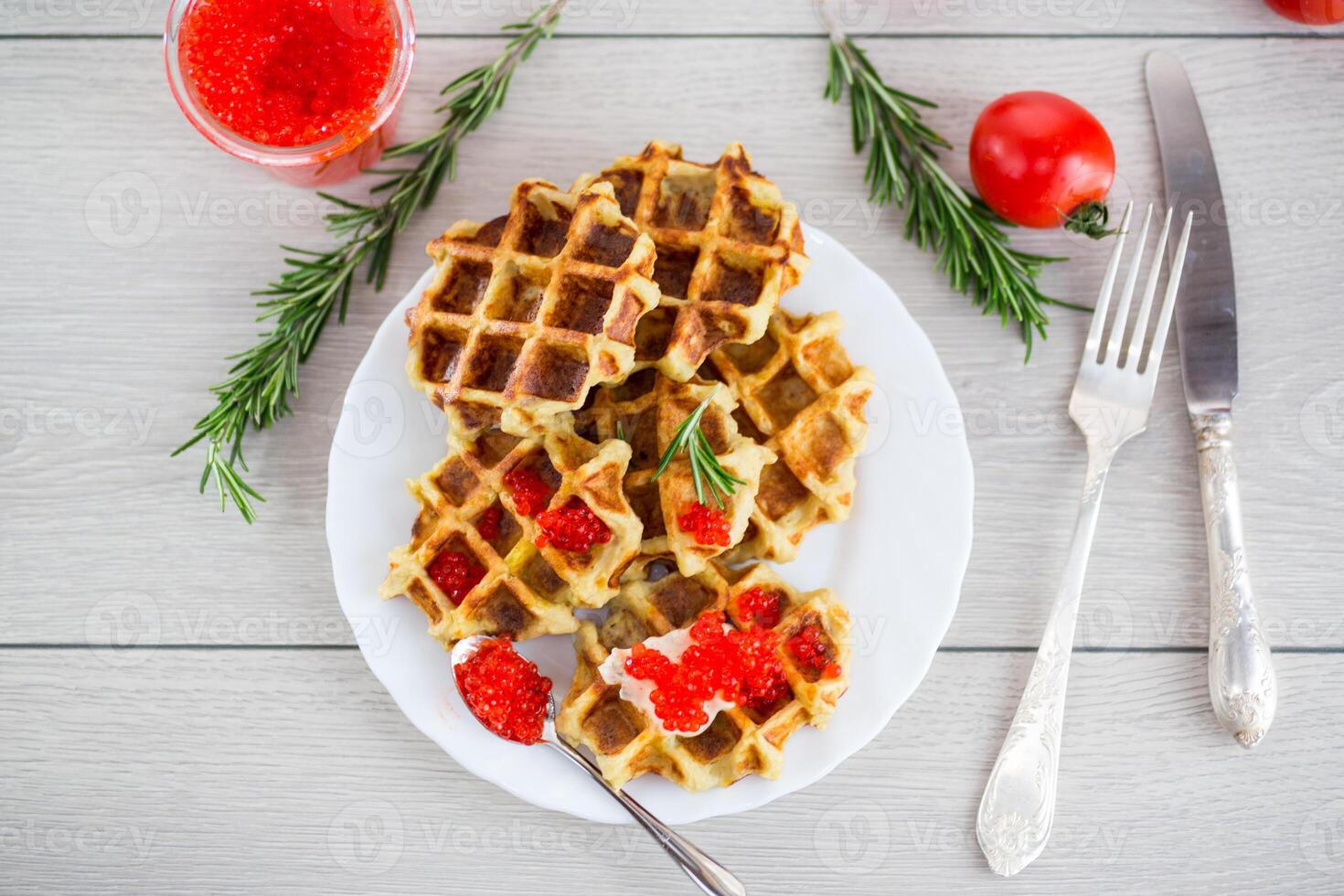 Quick and easy breakfast.Homemade potato waffles with caviar and herbs for breakfast photo