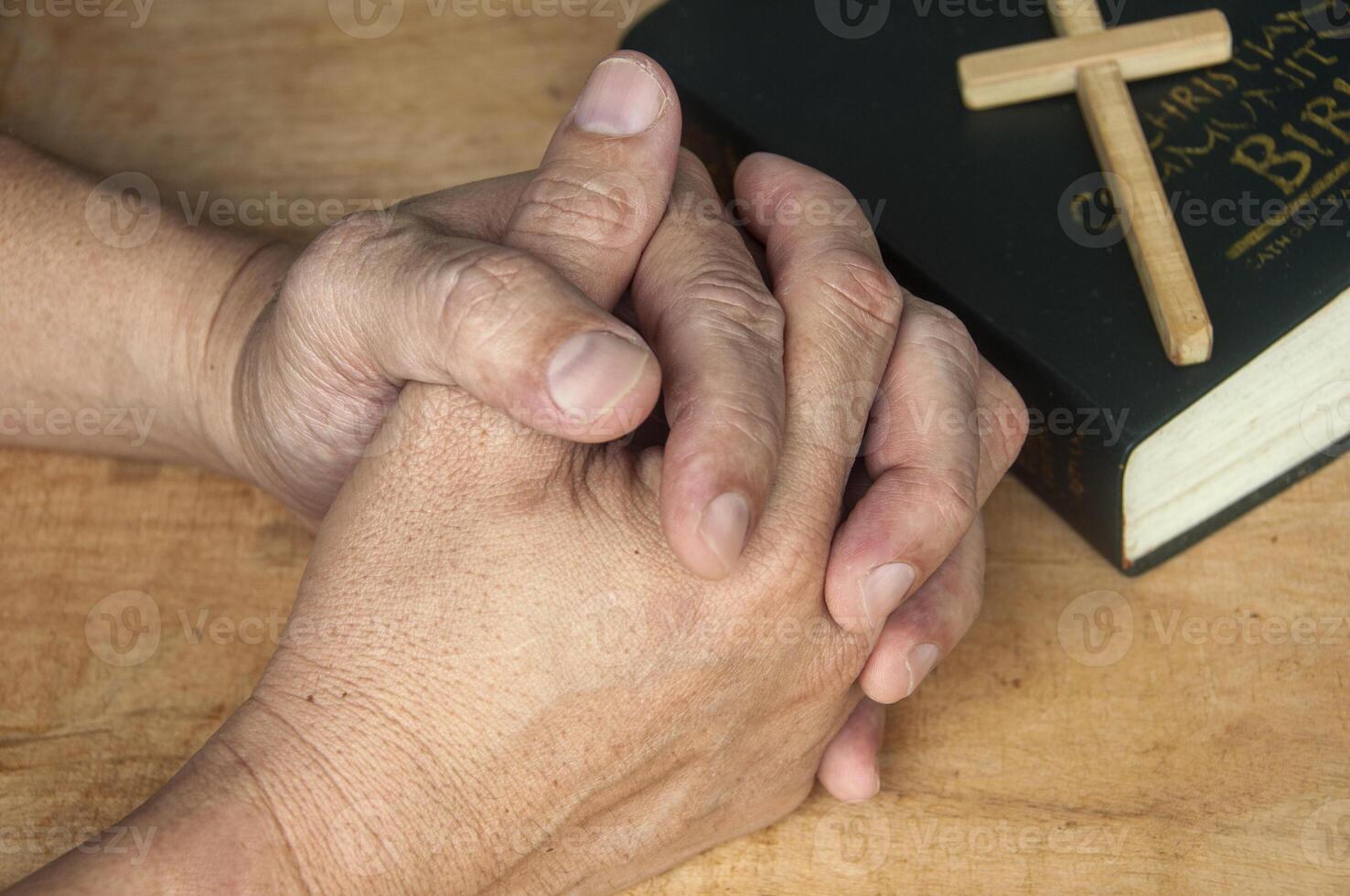 Two hands joined in reverent prayer reflect surrender, connection, and sacred communion with our heavenly Father above. photo